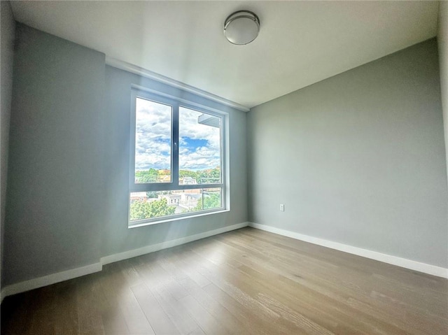 70-09 45th Ave Unit 7C, Woodside, NY 11377 - unfurnished room featuring baseboards and wood finished floors