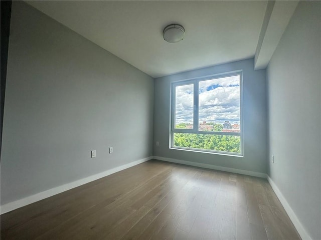 70-09 45th Ave Unit 7C, Woodside, NY 11377 - spare room with baseboards and wood finished floors