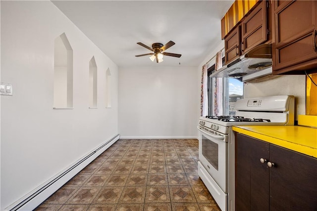 kitchen with gas range gas stove, ceiling fan, baseboard heating, light countertops, and under cabinet range hood