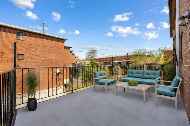 view of patio with an outdoor living space and a balcony
