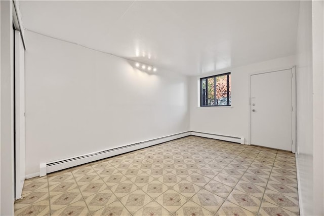 unfurnished room with light floors, a baseboard heating unit, and baseboard heating