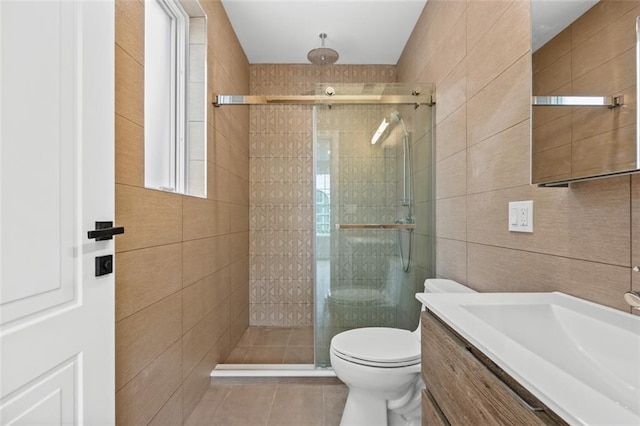 227 77th St, Brooklyn, NY 11209 - bathroom with tile walls, vanity, a stall shower, and tile patterned flooring