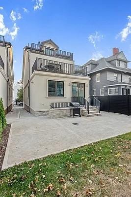 227 77th St, Brooklyn, NY 11209 - back of property featuring a balcony and a patio area