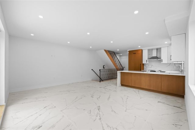 227 77th St, Brooklyn, NY 11209 - kitchen featuring open floor plan, wall chimney exhaust hood, brown cabinetry, recessed lighting, and a peninsula