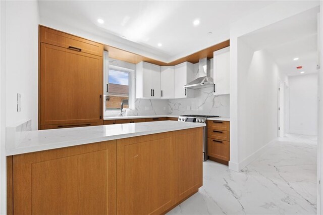 227 77th St, Brooklyn, NY 11209 - kitchen featuring wall chimney exhaust hood, gas stove, a peninsula, light marble finish flooring, and backsplash