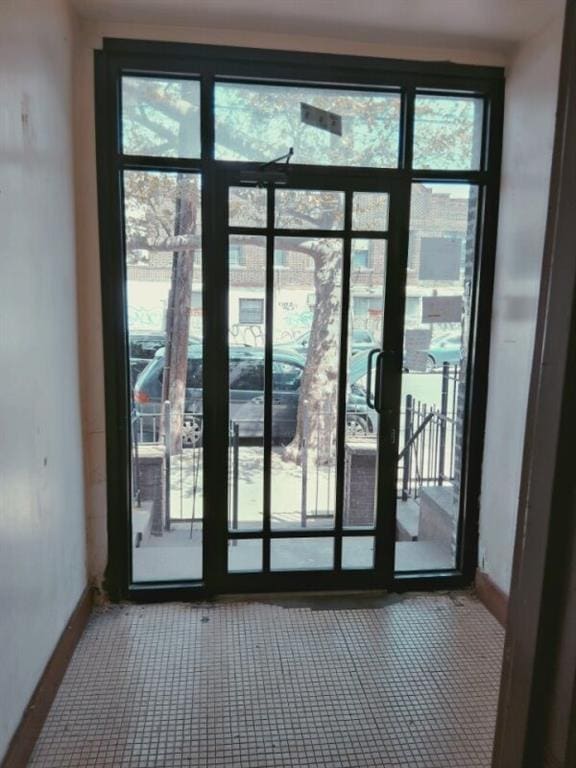 doorway to outside with baseboards