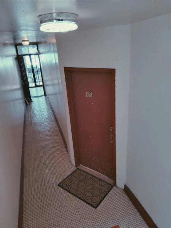 hall featuring baseboards