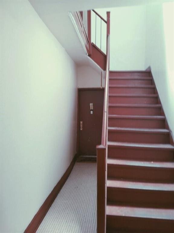 staircase with carpet floors and baseboards