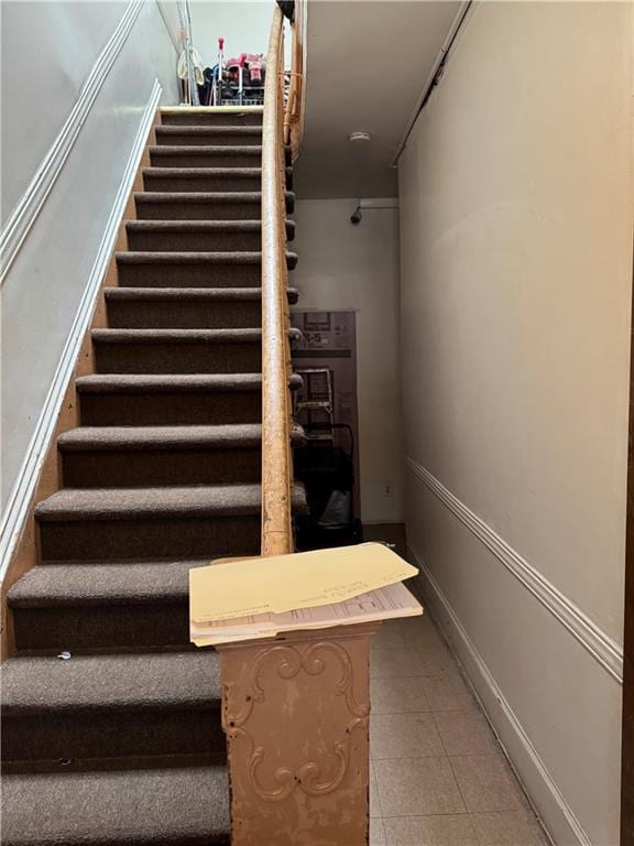 stairway with tile patterned floors