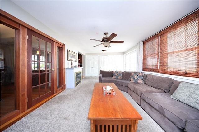 115 Wilson Ter, Staten Island, NY 10304 - living room with light carpet, ceiling fan, and a glass covered fireplace