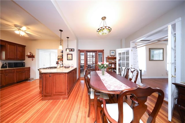 115 Wilson Ter, Staten Island, NY 10304 - dining space with french doors, light wood-style floors, and a ceiling fan