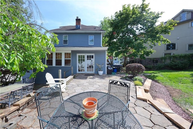 115 Wilson Ter, Staten Island, NY 10304 - rear view of property featuring outdoor dining area, a patio area, french doors, and a chimney