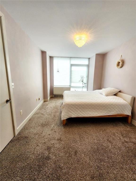 bedroom with carpet floors and baseboards