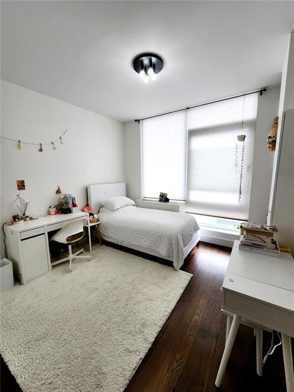 bedroom featuring dark wood finished floors