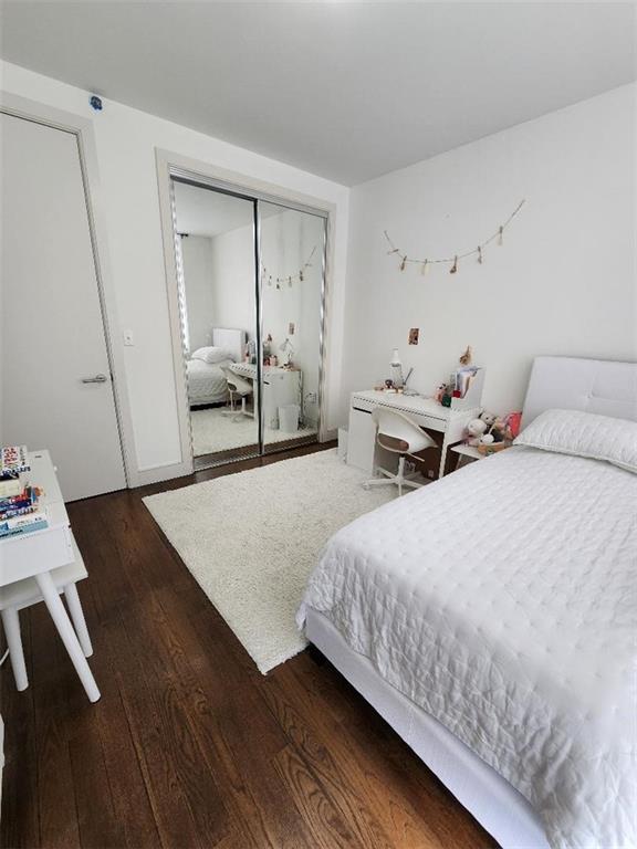 110 Neptune Ave Unit 3H, Brooklyn, NY 11235 - bedroom with dark wood finished floors and a closet