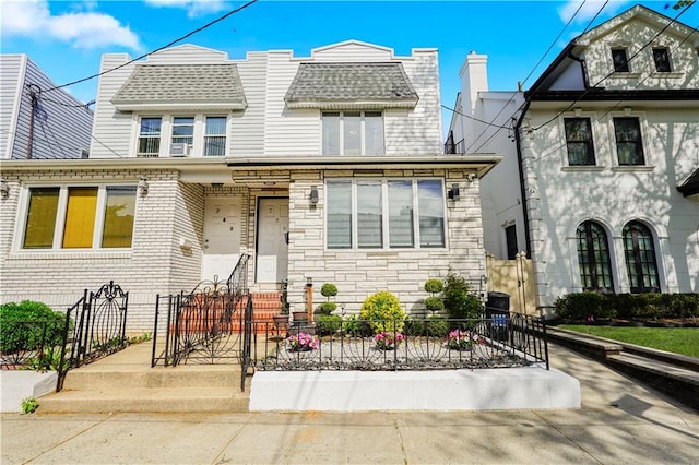 286 Bay 10th St, Brooklyn, NY 11228 - view of front of home featuring a fenced front yard, stone siding, and roof with shingles