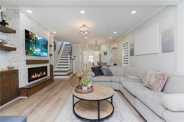 286 Bay 10th St, Brooklyn, NY 11228 - living room with ornamental molding, a stone fireplace, a wall mounted air conditioner, recessed lighting, and light wood finished floors
