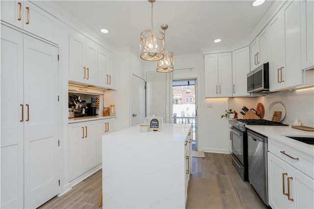 286 Bay 10th St, Brooklyn, NY 11228 - kitchen with appliances with stainless steel finishes, light wood-style floors, a chandelier, white cabinets, and recessed lighting