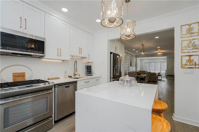 286 Bay 10th St, Brooklyn, NY 11228 - kitchen with stainless steel appliances, ornamental molding, a chandelier, a sink, and light wood-style flooring