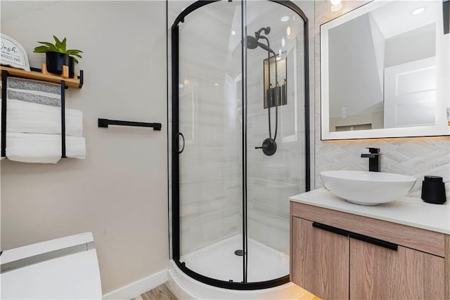 286 Bay 10th St, Brooklyn, NY 11228 - full bathroom with a stall shower, vanity, decorative backsplash, and baseboards