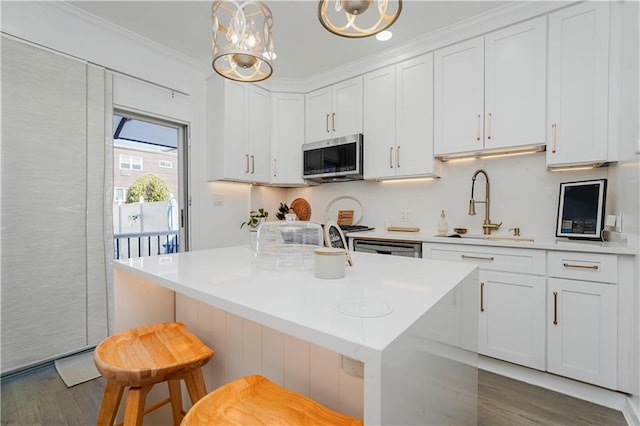 286 Bay 10th St, Brooklyn, NY 11228 - kitchen with a sink, stainless steel microwave, dark wood-style floors, white cabinetry, and light countertops