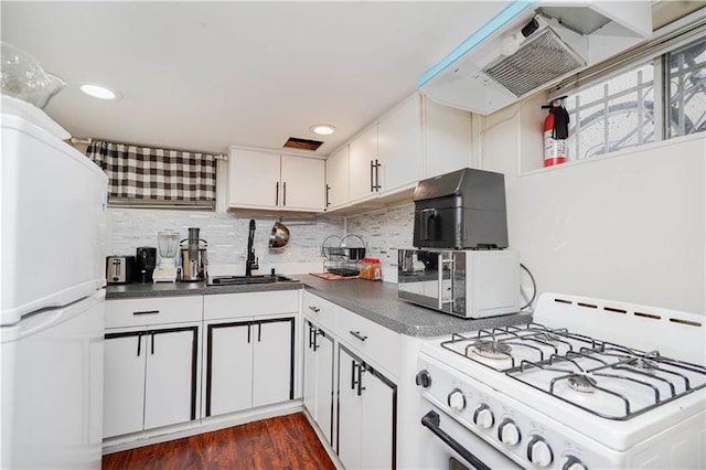 286 Bay 10th St, Brooklyn, NY 11228 - kitchen featuring white appliances, a sink, exhaust hood, dark countertops, and recessed lighting