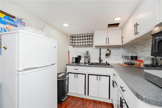 286 Bay 10th St, Brooklyn, NY 11228 - kitchen featuring freestanding refrigerator, a sink, dark countertops, dark wood-style floors, and white cabinetry