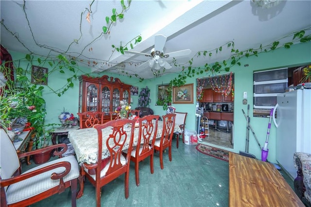 dining space with a ceiling fan and tile patterned floors
