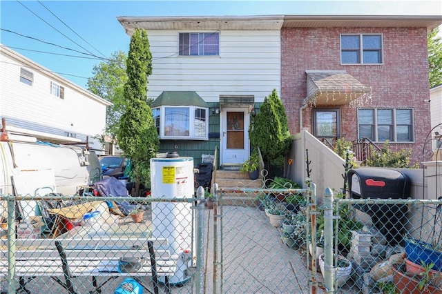 townhome / multi-family property with a gate and a fenced front yard