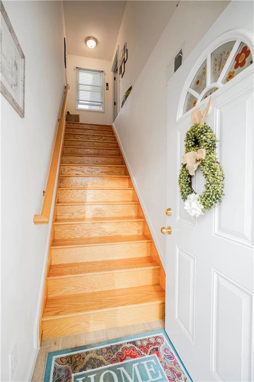 staircase featuring baseboards