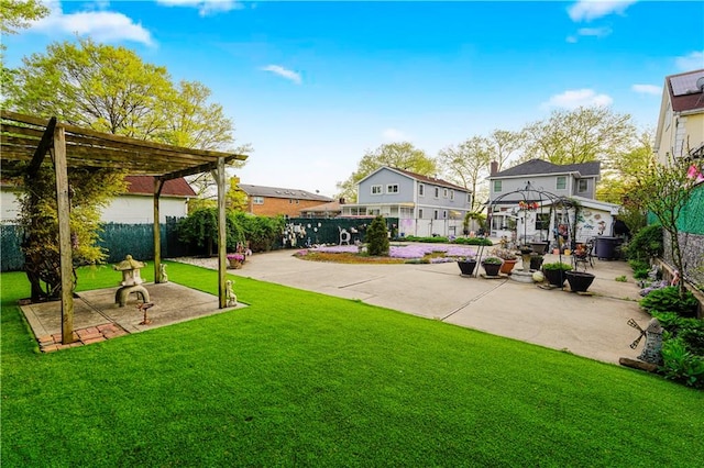 view of yard with a pergola, fence, a residential view, and a patio area
