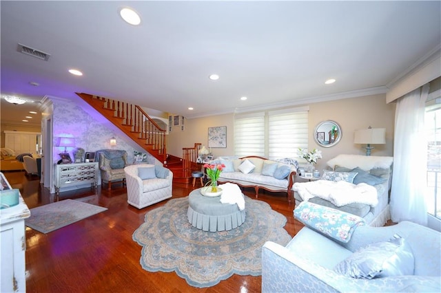 living area with crown molding, stairway, wood finished floors, and visible vents