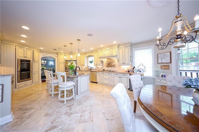 63 Finlay Ave, Staten Island, NY 10309 - kitchen featuring a wealth of natural light, a notable chandelier, appliances with stainless steel finishes, and cream cabinets