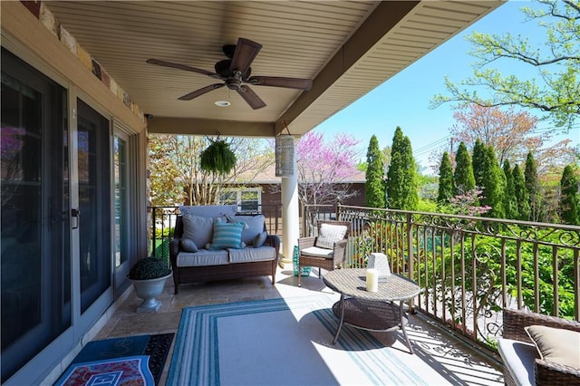 balcony featuring an outdoor living space and ceiling fan