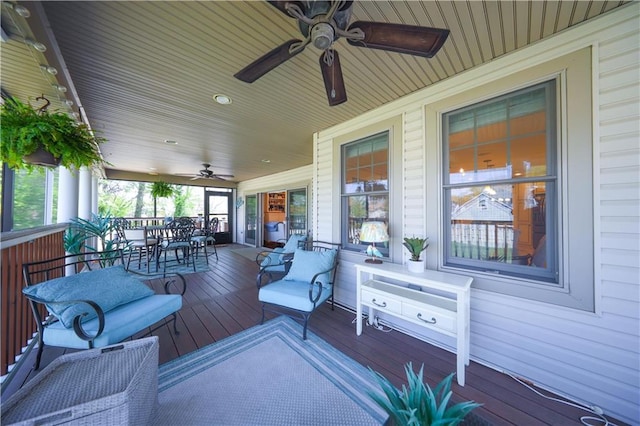 deck with a porch, a ceiling fan, and outdoor dining space