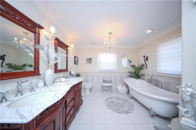 bathroom featuring an inviting chandelier, a sink, wainscoting, and a freestanding bath