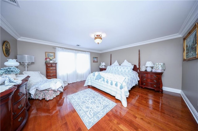 bedroom with visible vents, ornamental molding, and wood finished floors