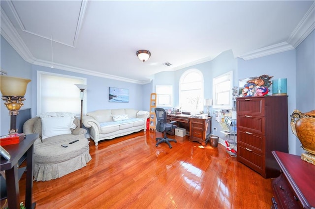 home office with light wood-type flooring, attic access, crown molding, and visible vents