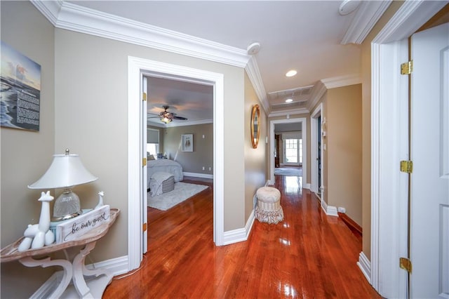 hallway with baseboards, ornamental molding, recessed lighting, and wood finished floors