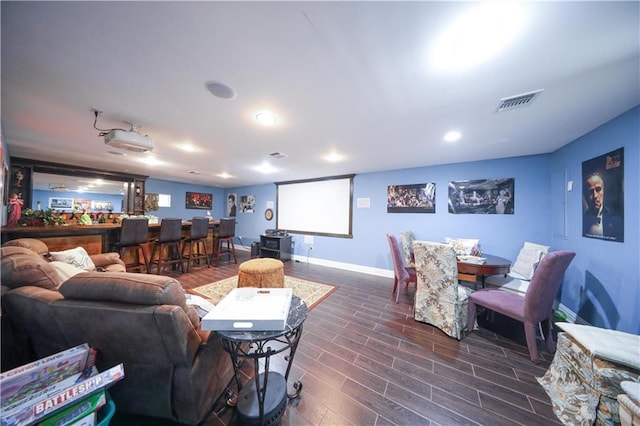 living room with visible vents, baseboards, dark wood-style floors, recessed lighting, and a bar