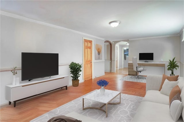 living area featuring baseboards, arched walkways, and ornamental molding