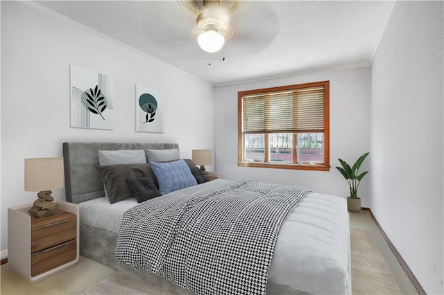 bedroom featuring light colored carpet, baseboards, crown molding, and ceiling fan