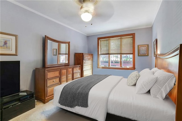 bedroom featuring light colored carpet, ornamental molding, and a ceiling fan