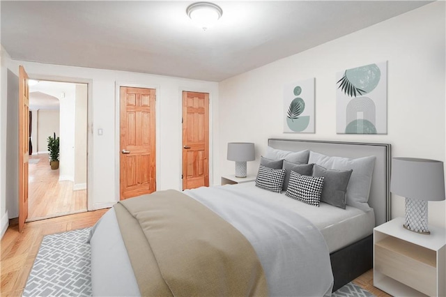 bedroom with baseboards and wood finished floors