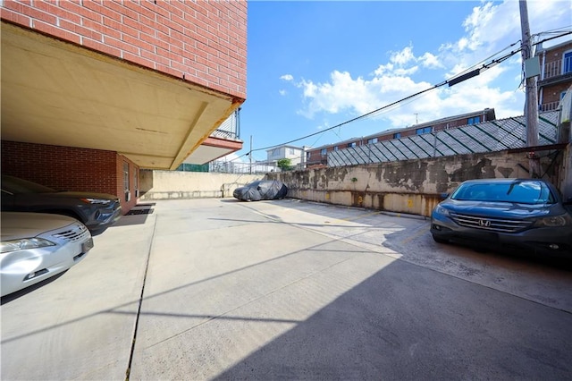 view of car parking with fence