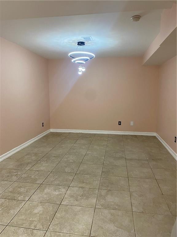 unfurnished room with baseboards, light tile patterned flooring, and visible vents