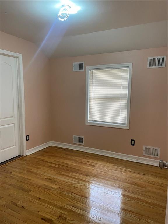 bonus room with visible vents and wood finished floors