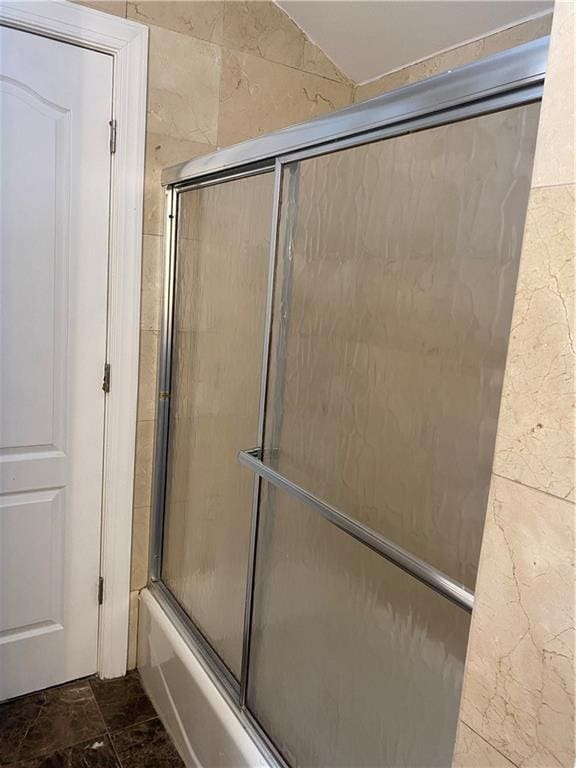 full bathroom with marble finish floor and enclosed tub / shower combo