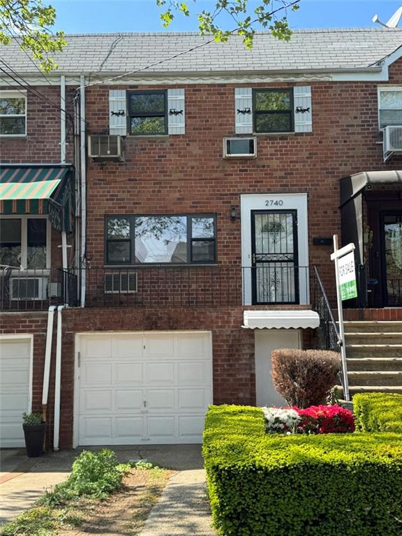 2740 E 63rd St, Brooklyn, NY 11234 - multi unit property with an attached garage, driveway, and brick siding