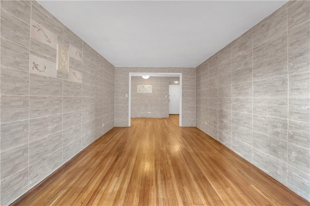 345 Webster Ave Unit 3N, Brooklyn, NY 11230 - empty room featuring tile walls and wood finished floors